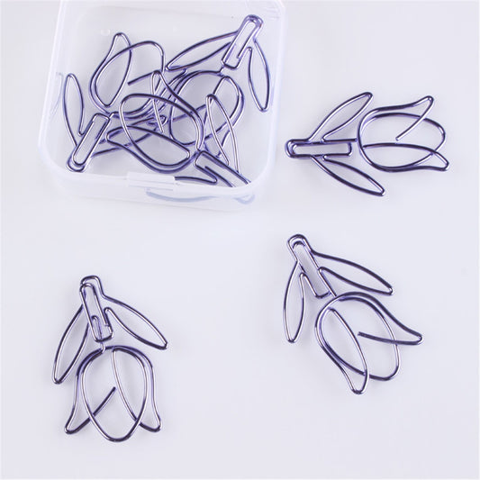 This product is a set of 12 purple tulip shaped paper clip bookmarks. The tulip shaped paper clips are made of thin metal wire that has been shaped and colored to look like purple tulips. The stem and leaves of the tulip are formed from the lower part of the paperclip while the flower petals flare out from the top part of the clip